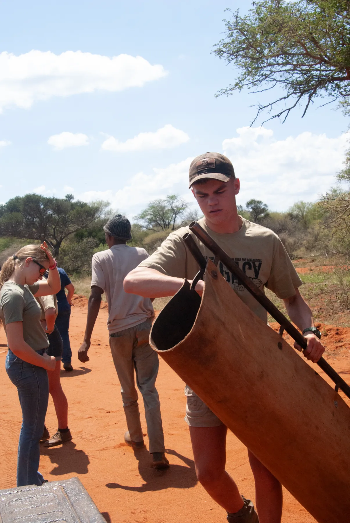 Students moving pipe on a ranch track